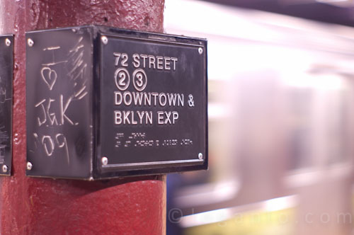 Shot of a train in NYC with a subway sign